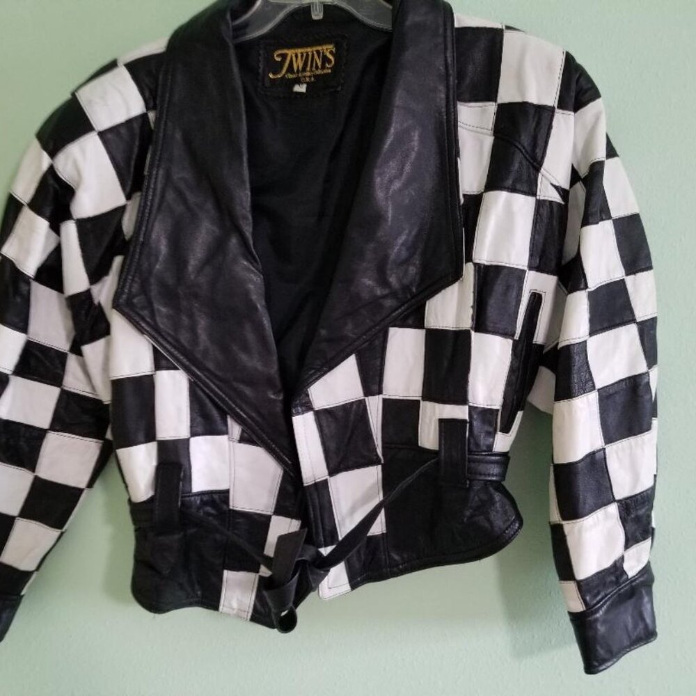 80's Twins black and white checkered leather jacket with tie belt closure.